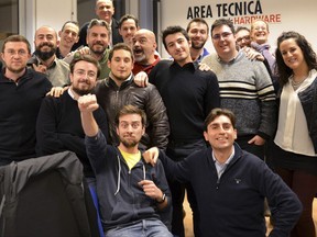 This December 2016 photo provided Friday, Aug. 18, 2017 by Tom's Hardware Italy shows Bruno Gulotta, at center wearing a black shirt, with his colleagues at their office in Legnano, near Milan, Italy. Gulotta is one of the 14 victims of Thursday's deadly van attack in Barcelona. (Tom's Hardware Italy via AP)