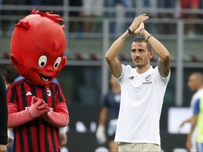 FILE - In this photo taken on Aug. 3, 2017, former Juventus player Leonardo Bonucci waves to his new fans, prior to the start of an Europa League third qualifying round, second leg, soccer match at the San Siro stadium in Milan, Italy. After three years without any appearances at all in Europe, AC Milan is looking to regain its place among football's elite. The Chinese-led consortium that purchased Milan from Berlusconi for $800 million in April has infused the club with cash and splashed out more than 200 million euros in the offseason. (AP Photo/Antonio Calanni, File)