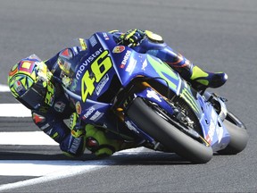 FILE -- In this Aug. 27, 2017 file photo, Italy's Valentino Rossi of Movistar Yamaha steers his bike during the Moto GP race at the British Grand Prix at Silverstone, England. Six-time MotoGP champion Rossi has reportedly broken his right leg in a training accident in Italy. According to Italian sports daily Gazzetta dello Sport, Rossi fell during enduro training and fractured his tibia and fibula. (AP Photo/Rui Vieira)