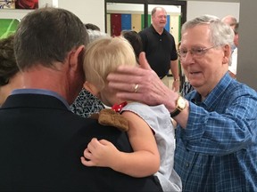 Senate Majority Leader Mitch McConnell greets constituents at the Graves County Republican Breakfast in Mayfield, Ky., on Saturday, Aug. 5, 2017. McConnell told Republicans not to be disheartened by the Senate's failure to repeal and replace former President Barack Obama's health care law, telling them: "We're not through."  (AP Photo/Adam Beam)