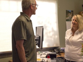 In this Friday, Aug. 11, 2017 photo Montana Health Co-op President Larry Turney chats Friday with chief external affairs officer, Ronda McMillan, at the co-op's offices in Helena, Mont. The health care co-op begins accepting new enrollees Sunday, Aug. 13, 2017, after voluntarily withdrawing from Montana's health insurance exchange to stave off insolvency. The Montana Co-op is just one of four health care co-ops that survives, among the 23 that sprung out of the Obama administration's Affordable Care Act. (AP photo/Bobby Caina Calvan)