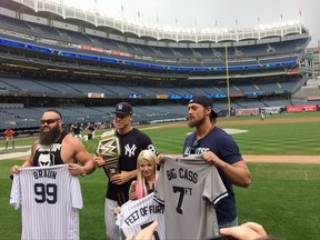 New York Yankees' Aaron Judge, second from left, poses for a photo with wrestlers William Morrissey, know as "Big Cass," right, Adam Joseph Scherr, known as "Braun Strowman," left, and Alexa Bliss "Five Feet of Fury," second from right before a baseball game between the Yankees and the New York Mets on Tuesday, Aug. 15, 2017. (AP Photo/Ben Walker