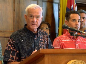 Honolulu Mayor Kirk Caldwell talks to reporters about problems with a rail funding bill on Monday, Aug. 28, 2017, in Honolulu. Officials at Honolulu's cash-strapped $9.5 billion rail project are under pressure to deliver an adequate funding plan to the federal government, and Hawaii lawmakers are meeting in a special legislative session to find a financial solution. (AP Photo/Cathy Bussewitz)