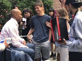 Former NBA basketball player Stephon Marbury, left, talks to NYU freshmen at a question and answer session Wednesday, Aug. 30, 2017, in New York. Marbury gave all the people in attendance a pair of his Starbury sneakers. Marbury had a few stellar seasons in China after an NBA career that included stints with five teams, and he's become an iconic figure in the country. He has a statue and was featured on a postage stamp in Beijing, and then he got a museum and a musical in his honor. (AP Photo/Doug Feinberg)
