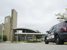 In this May 12, 2017, photo, a Churchill police cruiser sits near Woodland Hills High School in Churchill, Pa. The Pittsburgh-area school with a history of racial tension created a culture of verbal abuse and excessive force that allowed resource officers to shock students with stun guns and body-slam them, according to a civil rights lawsuit filed Wednesday, Aug. 23. (AP Photo/Dake Kang)