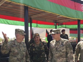 U.S. Gen. John Nicholson, top U.S. commander in Afghanistan, left, talks with Col. Khanullah Shuja, commander of the national mission brigade of the Afghan special operations force, and U.S. Gen. Joseph Votel, head of U.S. Central Command, at Camp Morehead in Afghanistan on Sunday, Aug. 20, 2017. The three officers attended the launch of the Afghan Army's new special operations corps. (AP Photo/Lolita Baldor)