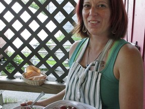 In this Aug. 1, 2017 photo, Jacki O'Connor serves new potatoes at a weekly farm dinner at Valley Dream Farm in Cambridge, Vt., featuring produce from the farm and other Vermont made products.  From California to food-loving Vermont, farmers are drawing customers to feast on foods raised in nearby fields.(AP Photo/Lisa Rathke)