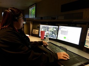 In this Tuesday, Aug. 29, 2017, photo, Erika Wells, a 911 operator, answers a call for help in the aftermath of Hurricane Harvey in Houston. Since the storm, the call center has been inundated with requests for help, from people trapped on flooded freeways or in their homes, to reports of looting and medical emergencies. (AP Photo/Matt Sedensky)