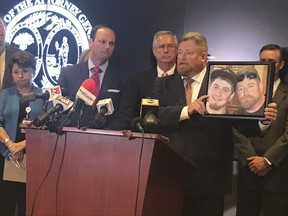 South Carolina Attorney General Alan Wilson, left, stands next to Rep. Eric Bedingfield, whose son died last year of a drug overdose, on Tuesday, Aug. 15, 2017, at his offices in Columbia, S.C. Wilson on Tuesday announced the state had sued Purdue Pharma, accusing the maker of OxyContin and other opioid drugs of violating South Carolina's Unfair Trade Practices Act. (AP Photo/Meg Kinnard)