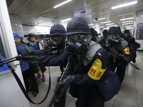 Police officers conduct an anti-terror drill as part of Ulchi Freedom Guardian exercise at a subway station in Seoul, South Korea, Tuesday, Aug. 22, 2017. As North Korea vowed "merciless retaliation" against U.S.-South Korean military drills it claims are an invasion rehearsal, senior U.S. military commanders on Tuesday dismissed calls to pause or downsize exercises they called crucial to countering a clear threat from Pyongyang.
