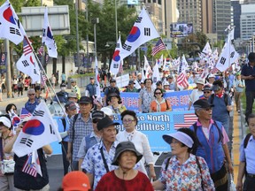 Supporers of former South Korean President Park Geun-hye march during a rally urging the deployment of an advanced U.S. missile defense system called Terminal High-Altitude Area Defense, or THAAD, in Seoul, South Korea, Saturday, Aug. 12, 2017. Chinese President Xi Jinping made a plea for cool-headedness over escalating tensions between the U.S. and North Korea in a phone conversation with U.S. President Donald Trump on Saturday, urging both sides to avoid words or actions that could worsen the situation. (AP Photo/Ahn Young-Joon)