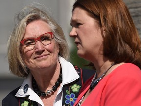 Carolyn Bennett (left), minister of Crown-Indigenous relations and northern affairs looks on as Indigenous Services Minister Jane Philpott speaks to media after a Liberal cabinet shuffle at Rideau Hall in Ottawa on Monday, Aug. 28, 2017. THE CANADIAN PRESS/Sean Kilpatrick