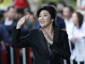 In this Aug. 1, 2017 photo, Thailand's former Prime Minister Yingluck Shinawatra waves to supporters as she arrives at the Supreme Court to make her final statements in a trial on a charge of criminal negligence in Bangkok, Thailand. Friends and foes alike of Yingluck Shinawatra, are anxiously awaiting a verdict Friday, Aug. 25, 2017 by the country's Supreme Court on charges that she was criminally negligent in implementing a rice subsidy program that is estimated to have cost the government as much as $17 billion and could now cost her 10 years in prison. (AP Photo/Sakchai Lalit)
