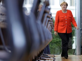 German Chancellor Angela Merkel arrives for her annual press conference at the Federal Press Conference in Berlin, Germany, Tuesday, Aug. 29, 2017. (AP Photo/Michael Sohn)