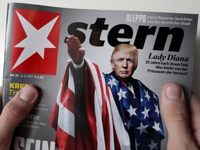 A person holds a copy of the 'Stern' news magazine in Berlin, Germany, showing U.S. President Donald Trump draped in the American flag while giving a stiff-armed Nazi salute.