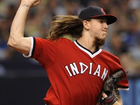 Cleveland Indians starter Mike Clevinger pitches against the Tampa Bay Rays during the first inning of a baseball game, Saturday, Aug. 12, 2017, in St. Petersburg, Fla. Both teams are wearing throw-back jerseys. (AP Photo/Steve Nesius)