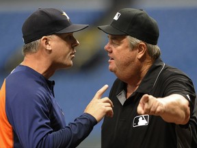 Houston Astros manager A.J. Hinch, left, argues with umpire Joe West after George Springer was called out at second base on a batter interference call during the first inning of a baseball game Thursday, Aug. 31, 2017, in St. Petersburg, Fla. Hinch was tossed from the game by West. (AP Photo/Steve Nesius)