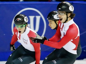 Canada's Charle Cournoyer, left, celebrates his gold medal in the men's 1000 metres at the ISU World Cup short track championships with teammate and silver medalist Samuel Girard on Nov. 6, 2016.