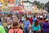Streams of visitors walk along food vendors at the Iowa State Fair.