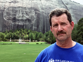 John Purpera in front of the carvings of Confederate leaders in Georgia’s Stone Mountain State Park. "The people that want it removed should be shot," he said.