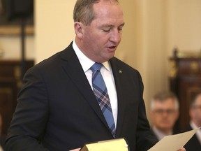 In this July 19, 2016, file photo Australia's Deputy Prime Minister Barnaby Joyce takes the oath of office as he is sworn in at Government House in Canberra, Australia. Joyce, on Monday, Aug. 14, 2017, became the latest lawmaker to reveal he might have breached a constitutional prohibition on dual citizens becoming lawmakers, after he was advised by the New Zealand government that he might be a kiwi. (AP Photo/Rob Griffith, File)