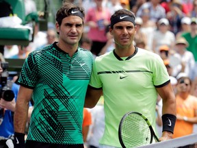 In this April 2 file photo, Roger Federer (left) and Rafael Nadal pose at the net before meeting in the final of the Miami Open.