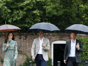 Britain's Prince William, center, his wife Kate, Duchess of Cambridge and Prince Harry arrive for an event at the memorial garden in Kensington Palace, London, Wednesday, Aug. 30, 2017. Princes William and Harry are paying tribute to their mother, Princess Diana, on the eve of the 20th anniversary of her death by visiting the Sunken Garden to honor Diana's work with charities. (AP Photo/Kirsty Wigglesworth)