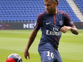 Brazilian soccer star Neymar controls the ball following a press conference in Paris Friday, Aug. 4, 2017. Neymar arrived in Paris on Friday the day after he became the most expensive player in soccer history when completing his blockbuster transfer to Paris Saint-Germain from Barcelona for 222 million euros ($262 million).(AP Photo/Michel Euler)