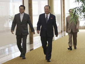 North Korean Foreign Minister Ri Yong Ho, center, walks as he leaves for the Philippines to participate in the ministerial meeting of the Association of Southeast Asian Nations, or ASEAN, Regional Forum, at the Pyongyang Airport in Pyongyang, North Korea, Saturday, Aug. 5, 2017. Alarm over North Korea's missile tests, a tentative step to temper South China Sea disputes, and unease over a disastrous siege by pro-Islamic State group militants will grab the spotlight at annual meetings of Southeast Asia's top diplomats and their Asian and Western counterparts. (AP Photo/Jon Chol Jin)