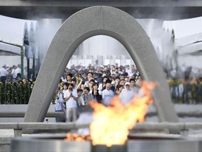 People offer prayers at the Peace Memorial Park in Hiroshima, western Japan, Sunday, Aug. 6, 2017, to mark the 72nd anniversary of the world's first atomic bombing that killed 140,000 people in 1945. Hiroshima's appeal of "never again" on the 72nd anniversary has acquired renewed urgency as North Korea moves ever closer to acquiring nuclear weapons. (Ryosuke Ozawa/Kyodo News via AP)