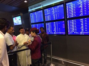 FILE - In this June 5, 2017 file photo, passengers of cancelled flights wait in Hamad International Airport in Doha, Qatar after Saudi Arabia and other Arab powers severed diplomatic ties with Qatar and moved to isolate the energy-rich nation. Qatar restored full diplomatic relations with Iran early Thursday, Aug. 24, 2017, disregarding the demands of Arab nations now locked in a regional dispute with the energy-rich country that it lessen its ties to Tehran. (AP Photo/Hadi Mizban, File)
