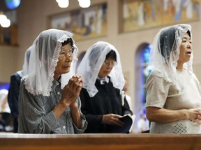 Prayers attend a mass at a church in Nagasaki to mark the 72nd anniversary of the world's second atomic bomb attack over the southwestern city, Wednesday, Aug. 9, 2017. (Takuto Kaneko/Kyodo News via AP)