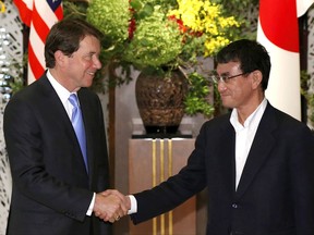 New U.S. Ambassador to Japan William Hagerty, left, is welcomed by Japan's Foreign Minister Taro Kono upon his arrival for a luncheon hosted by Kono at the foreign ministry's Iikura guest house in Tokyo, Japan Tuesday, Aug. 22, 2017. (Issei Kato/Pool Photo via AP)