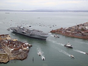HMS Queen Elizabeth arrives at its home port in southern England to great fanfare.  Crowds lined the harbor on Wednesday to welcome the ship to Portsmouth Naval Base, where it will be based for its estimated 50-year lifespan.