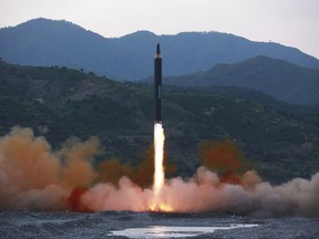 This May 14, 2017, file photo distributed by the North Korean government shows the "Hwasong-12," a new type of ballistic missile at an undisclosed location in North Korea. North Korea claims it is in the final stages of preparing a plan to launch four intermediate-range ballistic missiles over Japan and into waters just off the island of Guam, where about 7,000 U.S. troops are based.Independent journalists were not given access to cover the event depicted in this photo.
