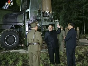 FILE - In this file image made from video by North Korea's KRT released on July 28, 2017, North Korean leader Kim Jung Un, second from right, gestures at the site of a missile test at an undisclosed location in North Korea. North Korea claims it is in the final stages of preparing a plan to launch four intermediate-range ballistic missiles over Japan and into waters just off the island of Guam, where about 7,000 U.S. troops are based. Kim has radically accelerated the pace of the North's missile development, and many experts believe it could have an intercontinental ballistic missile able to hit major American cities within a year or two. (KRT via AP Video, File)
