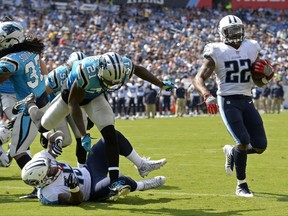 Tennessee Titans running back Derrick Henry (22) scores his second touchdown of the game on a 1-yard run ahead of Carolina Panthers defensive back Teddy Williams (21) in the first half of an NFL football preseason game, Saturday, Aug. 19, 2017, in Nashville, Tenn. (AP Photo/Mark Zaleski)