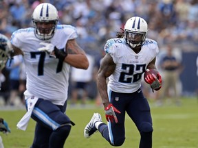 Tennessee Titans running back Derrick Henry (22) follows the blocking of tackle Taylor Lewan (77) against the Carolina Panthers in the first half of an NFL football preseason game, Saturday, Aug. 19, 2017, in Nashville, Tenn. (AP Photo/Mark Zaleski)