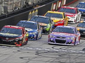 Erik Jones (77) leads Kyle Larson (42) and the rest of the field across the start line during the NASCAR Cup Series auto race, Saturday, Aug. 19, 2017 in Bristol, Tenn. (AP Photo/Wade Payne)