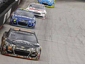 Driver Dale Earnhardt Jr. (88) leads Jimmie Johnson (48) and Matt DeBenedetto (32) during practice for the NASCAR Monster Energy Cup auto race, Friday, Aug. 18, 2017 in Bristol, Tenn. (AP Photo/Wade Payne)