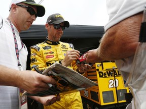 Driver Matt Kenseth signs autographs for fans after practice for the NASCAR Monster Energy Cup Series auto race, Friday, Aug. 18, 2017, in Bristol, Tenn. (AP Photo/Wade Payne)