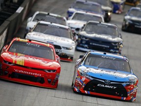 Justin Allgaier (7) and Kyle Busch (18) vie for the lead during the NASCAR Xfinity Series auto race, Friday, Aug. 18, 2017 in Bristol, Tenn. (AP Photo/Wade Payne)