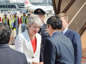 British Prime Minister Theresa May is greeted on her arrival at Itami airport, Osaka, Wednesday, Aug. 30, 2017.  May has arrived in Japan for a three-day visit that is expected to focus on Brexit, trade and security. (Kyodo News via AP)