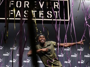 Usain Bolt gestures at a press conference in London on Aug. 1.