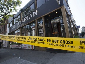 Toronto Police investigate a late night homicide on the patio of the Libertarian at Queen Street East and Sherborne Street in Toronto.