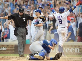 Chicago Cubs SS Javier Baez scores the winning run against the Toronto Blue Jays on Aug. 20.