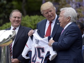 In this April 19, 2017 file photo, President Donald Trump is presented with a New England Patriots jersey from Patriots owner Robert Kraft, right, and head coach Bill Belichick during a ceremony on the South Lawn of the White House in Washington, where the Patriots were honoured for their Super Bowl LI victory. In addition to the jersey, the team confirmed on Tuesday, Aug. 22, 2017, that Kraft decided after the team's visit to also have a Super Bowl championship ring made for Trump.