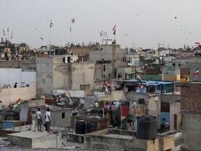 In this Tuesday, Aug. 15, 2017 photo, Indians fly kites on rooftops during Independence Day celebrations in the old quarters of New Delhi, India. The annual tradition of flying kites over the Indian capital on Independence Day takes a painful toll on birds that fall victim to their razor-sharp strings. It happens mostly to pigeons but also to crows, eagles and parrots. (AP Photo/Tsering Topgyal)