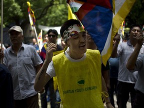 Exile Tibetans shout slogans during a protest to show support with India on Doklam Plateau standoff with China, in New Delhi, India, Friday, Aug. 11, 2017. Tensions between Indian and China flared last month in the southernmost part of Tibet, in an area also claimed by Indian ally Bhutan, after Chinese teams began building a road onto the Doklam Plateau. (AP Photo/Tsering Topgyal)