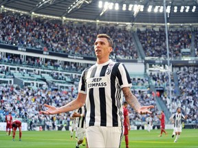 Juventus' Mario Mandzukic celebrates after scoring during a Serie A soccer match between Juventus and Cagliari, in Turin, Italy, Saturday, Aug. 19, 2017. (Alessandro Di Marco/ANSA via AP)